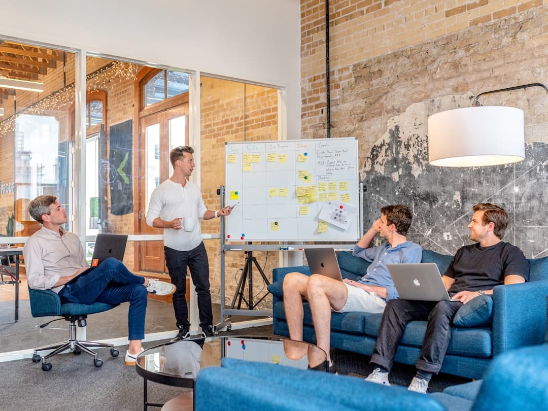 Team collaborating at a whiteboard — the collective approach behind PoolCures